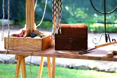 Close-up of rope on table against trees