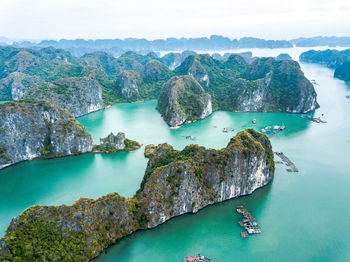 High angle view of rocks in sea against sky