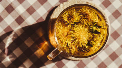 Dandelion flower healthy tea in glass cup on table. herbal medicine delicious tisane tea from with