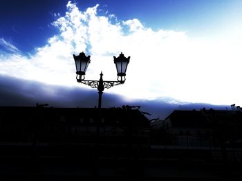 Low angle view of silhouette built structure against sky