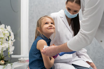 Female doctor examining patient at clinic