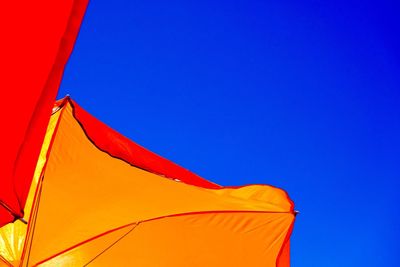 Low angle view of parasol against clear sky