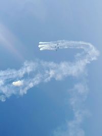 Low angle view of airplane flying against sky