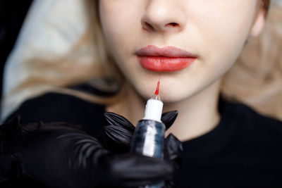 Close-up of woman holding syringe