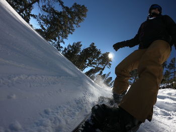 Low angle view of man on snowboarding against sky