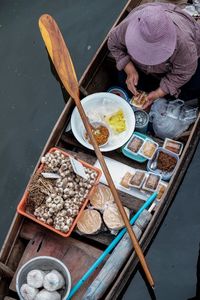 High angle view of man selling food at floating market