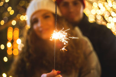 Low angle view of firework display at night