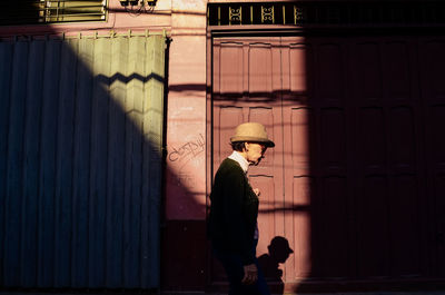 Man standing against wall in building