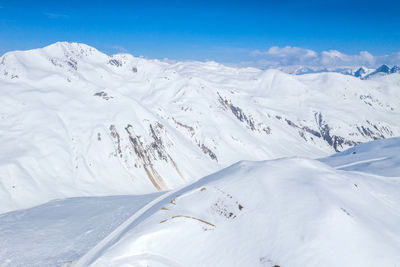 Scenic view of snowcapped mountains against sky