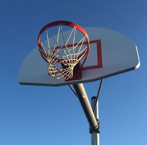 Low angle view of lighting equipment against blue sky