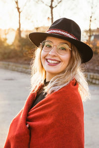 Portrait of smiling young woman wearing hat