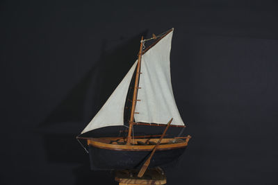 Low angle view of sailboat hanging on rope at night