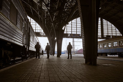 Rear view of people walking on footpath