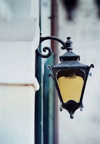 Close-up of lantern hanging on wall