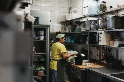 Woman working in cafe kitchen