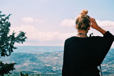 Rear view of woman looking at mountain landscape