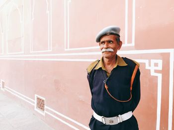 Portrait of mid adult man standing in city