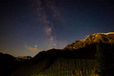 Scenic view of mountains against sky at night