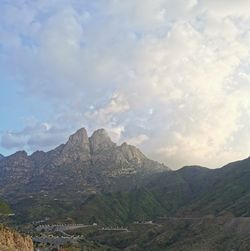 View of mountain range against cloudy sky