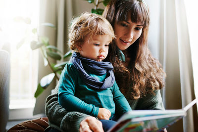 Mother and daughter sitting at home