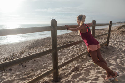 Full length of woman on beach against sky