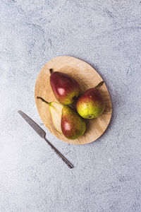 Three pears on wooden plate flatlay