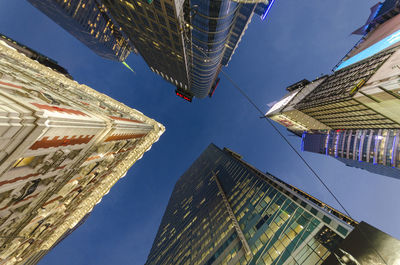 Low angle view of skyscrapers against clear blue sky