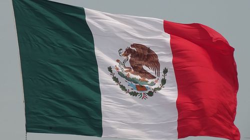 Low angle view of flags hanging against sky