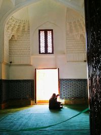 People sitting in corridor of building