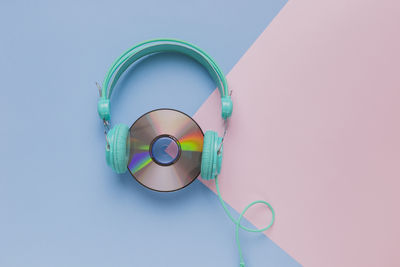 Directly above shot of headphones against colored background