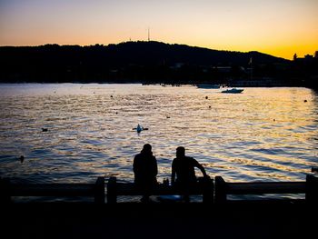 Scenic view of lake at sunset