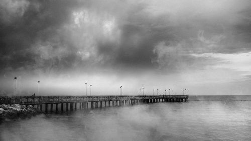 Pier over sea against sky