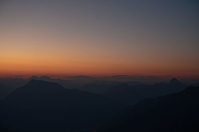 Scenic view of silhouette mountains against sky during sunset