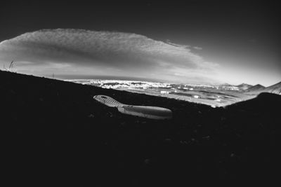 Airplane flying over landscape against sky