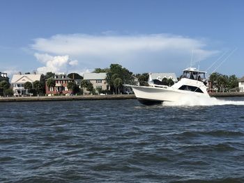 Boat sailing on sea against sky