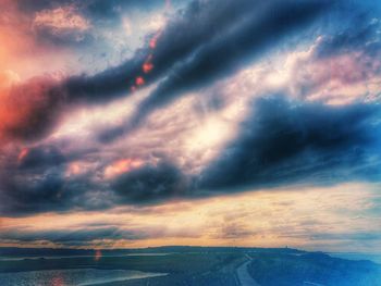 Scenic view of dramatic sky over sea during sunset