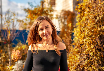 Portrait of a beautiful woman in an autumn garden