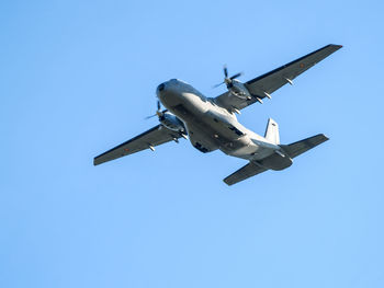 Low angle view of airplane flying against clear sky