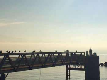 Bridge over sea against sky