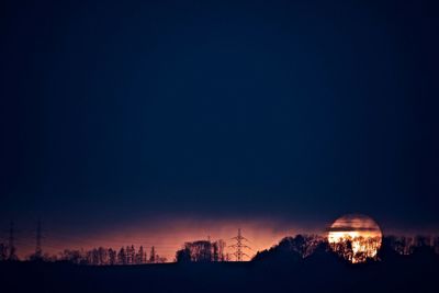 Scenic view of field against clear sky at night