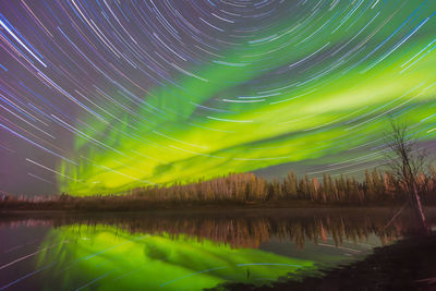 Scenic view of lake against sky at night