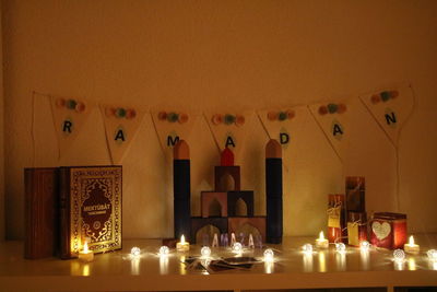 Illuminated lamps on table at home