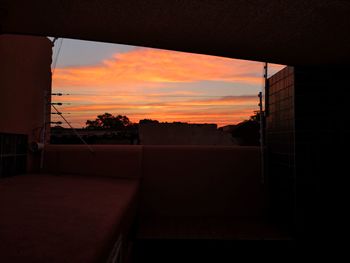 Silhouette buildings against sky during sunset