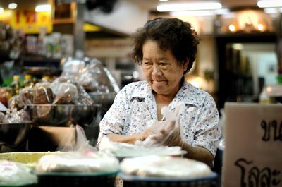 Portrait of woman with ice cream at market