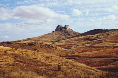 Scenic view of arid landscape against sky