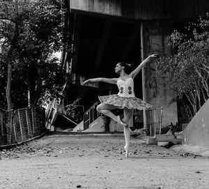 Full length of young woman on road