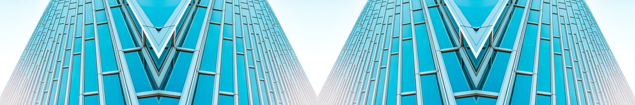 Low angle view of blue building against sky