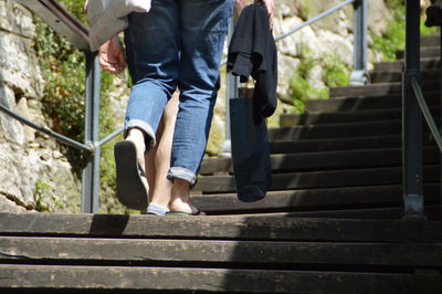 Low section of woman walking on steps