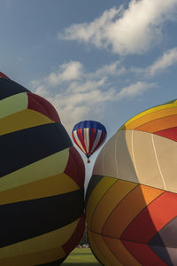 Low angle view of hot air balloons against sky 