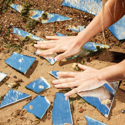 Cropped hands of man standing on footpath